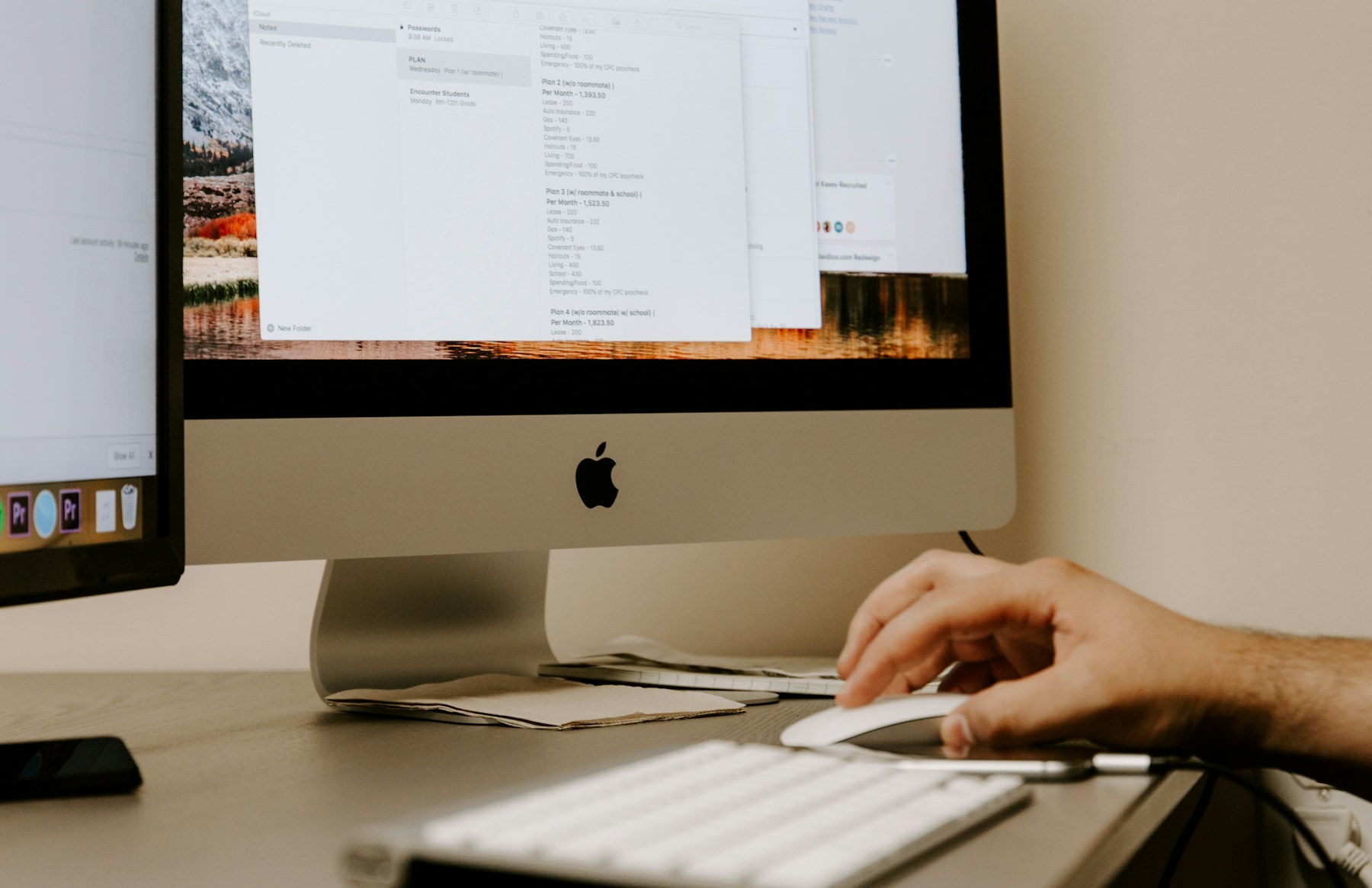 Person working at a desktop computer with two monitors.